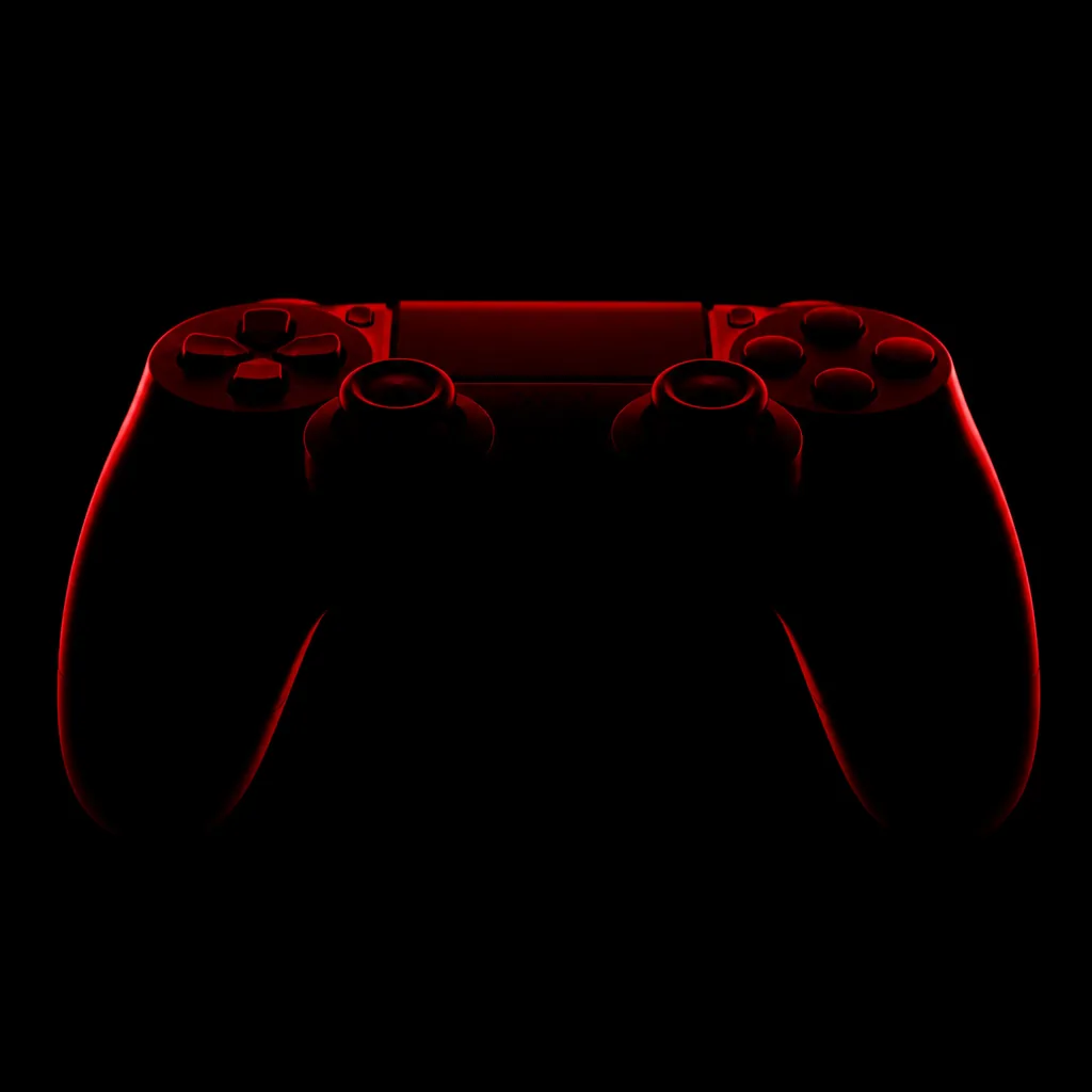 Silueta de un joystick con luz roja sobre fondo negro / Controller silhouette rim-lit in red on black